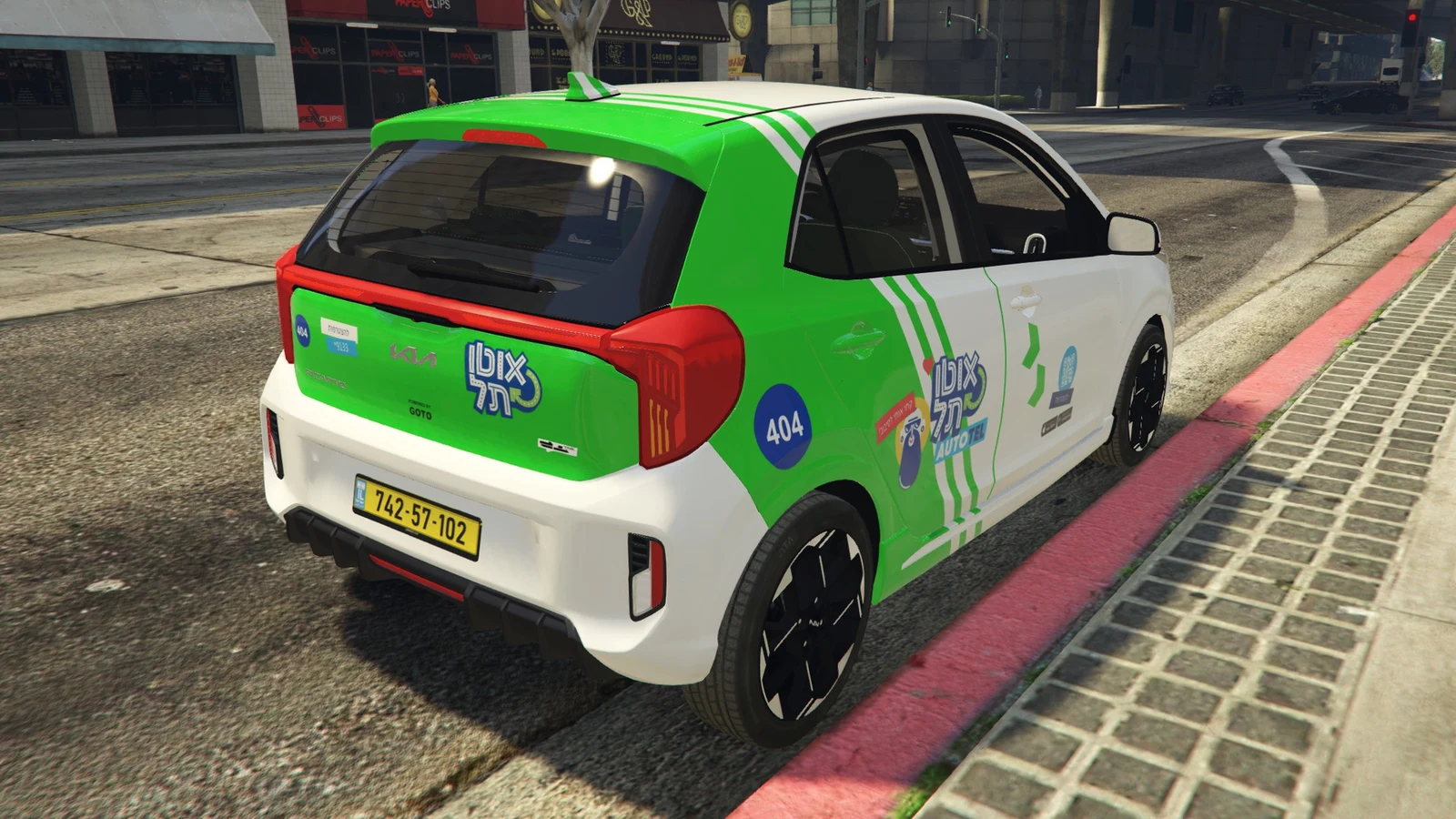 The Autotel Picanto from the rear three-quarter: the green rear, the stripes and 404